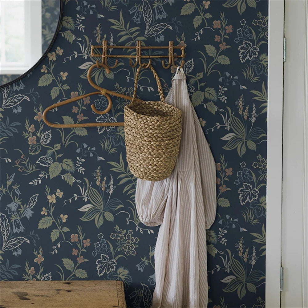 Ornate brass coat rack with woven basket and fabric, complementing Behang Bloemen Donkergroen